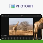 The image shows a computer screen displaying PhotoKit Photo Editor with a giraffe photo being edited. Another giraffe stands outside the screen, partially overlapping the monitor, showcasing why this ultimate photo editor is getting such exciting reviews.