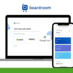 A laptop and smartphone display the Boardroom app interface, showing integration options for Shopify, Amazon, and Google Ads. A green "S.A.S OUR REVIEWS" logo is in the top left corner.